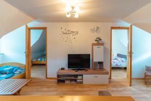 a living room with a tv and two beds at Holiday Home Lanita with Two Bedrooms & Terrace 