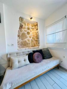 a bed in a room with a stone wall at Casa natura - Olib, gem of islands in Olib