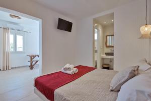 a bedroom with a bed with two towels on it at Casa Philippi Suites in Mikonos