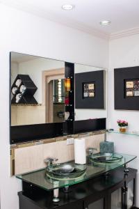 a bathroom with two sinks and a large mirror at ZenBreak Bliss Tranquility in Bridgetown