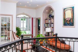 a staircase in a living room with a book shelf at ZenBreak Bliss Tranquility in Bridgetown