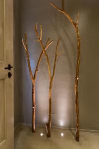 three tree trunks in a room with a wall at Terra di Gradara in Gradara