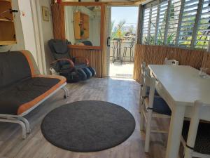 a living room with a couch and a table and chairs at Indigo roof garden Apt. 1BR 1BA in Tel Aviv
