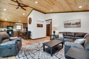 a living room with leather furniture and a wooden ceiling at Hatfield Vacation Rental with Private Hot Tub! in Merrillan