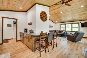 a kitchen and living room with a clock on the wall at Hatfield Vacation Rental with Private Hot Tub! in Merrillan