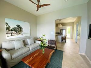 a living room with a couch and a coffee table at Sunset Reef St. Kitts in Ottleyʼs