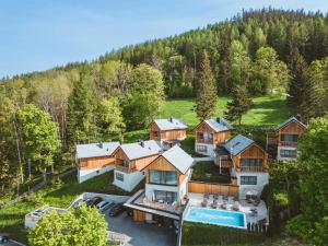 an aerial view of a house in the woods at Hideaway Hotel Montestyria Chalets & Suiten in Mariazell