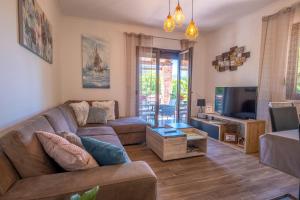 a living room with a couch and a tv at Villa Michelle in Grižane