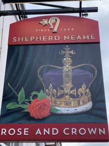 a sign for a shop with a crown on it at The Rose and Crown in Elham