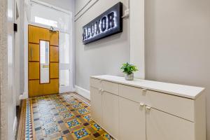 a lobby with a sign on the wall and a door at Perfect Location for Long Stays in Leicester