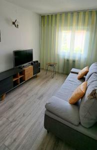 a living room with a couch and a flat screen tv at Klementina in Mali Lošinj