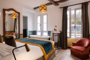 a bedroom with a bed and a tub and a sink at Le Village Montmartre by Hiphophostels in Paris