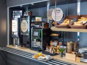 a bakery counter with bread and pastries on display at B&B HOTEL Rennes Sud Chantepie in Rennes