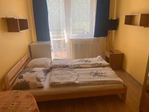 two beds in a room with a window at GWIAZDA MORZA in Hel