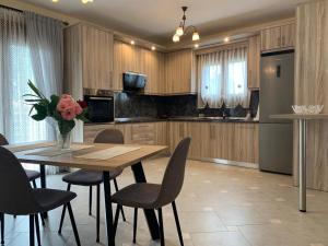 a kitchen with a wooden table and chairs at Holiday home in Nea Kallikratia in Nea Kalikratia