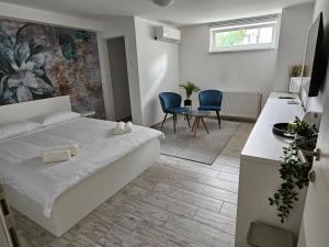 a living room with a bed and a table and chairs at Comfort Rooms Remiza - Private Parking - Self check-in in Zagreb