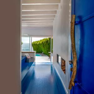 a hallway with blue flooring in a house at Adika in Ma'ale Gamla