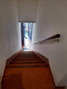 a staircase in a building with a person walking down it at Le Grand Hotel Restaurant in Aups +31 photos