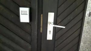a black garage door with a lock on it at Waldhaus Wiesengrund in Schwielochsee