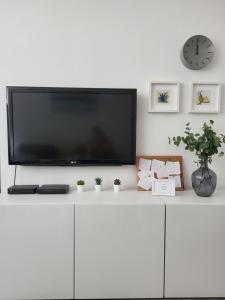 a flat screen tv sitting on top of a white cabinet at Split Mari Apartment in Split