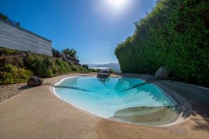 a large swimming pool in the middle of a yard at Adika in Ma'ale Gamla