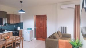 a kitchen and a living room with a couch and a table at limonchello 2 in Kalamata +10 photos