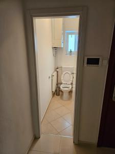 an open door to a bathroom with a toilet at Comfort Rooms Remiza in Zagreb