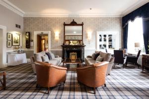 a living room with couches and a table and a mirror at Royal Scots Club in Edinburgh