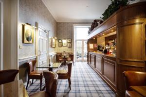 a bar in a restaurant with chairs and a table at Royal Scots Club in Edinburgh