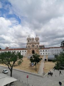 an old building with a clock tower in front of it at Hostel Rossio Alcobaça in Alcobaça