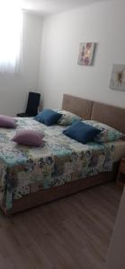 a bed in a bedroom with a laptop on it at Apartman Elza in Split