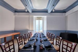 a long dining room with a long table and chairs at chateau d'escart in Arvillard