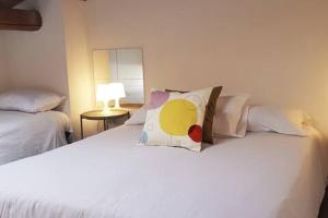 a white bed with a pillow on top of it at L'Artista in Trecastagni