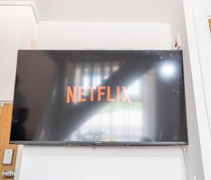 a television screen with the netflix sign on it at Bv Kirkstall Central 1 Bedroom Apt Free Private Parking in Leeds