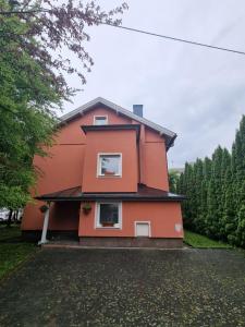 a orange house with two windows on the side of it at Cozy Nest in Salzburg