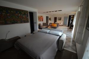 a bedroom with a large bed and a living room at Pikes in Pulfero