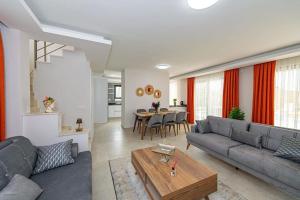 a living room with a couch and a table at Villa Lina Ölüdeniz/Fethiye in Fethiye