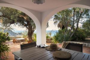 a table with a hat sitting on top of a patio at Stunning seaview villa in Altavilla Milicia