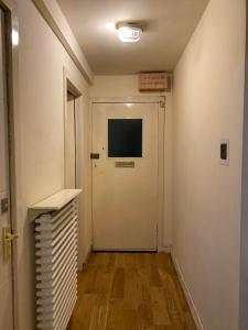 un couloir avec une porte et une télévision murale dans l'établissement EDI b&b, à Édimbourg