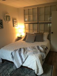 a bedroom with a large bed with a headboard at Cheerful 2 Bedroom Cottage on 5th in Decatur