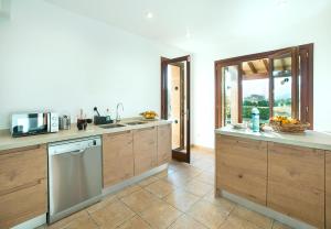 A kitchen or kitchenette at Owl Booking Villa Siquier - Luxury Retreat with Mountain Views