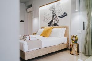 Un dormitorio con una cama con un cuadro en la pared. en Villa Sece - Luxury Rooms, en Agrigento