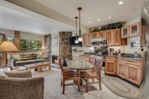 a kitchen and living room with a table and chairs at Laurelwood Condominiums 207 in Snowmass Village