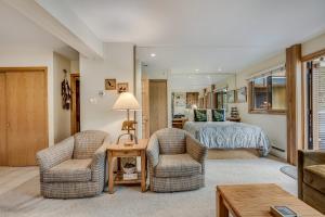 a living room with two chairs and a bed at Laurelwood Condominiums 207 in Snowmass Village