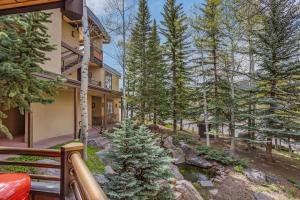 an exterior view of a house with a river and trees at Laurelwood Condominiums 207 in Snowmass Village