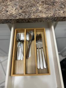 a drawer with silver utensils in a kitchen counter at Spacious room with TV, Wi-Fi, Netflix, Parking in Edmonton