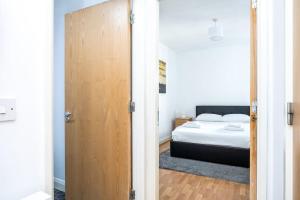 1 dormitorio con 1 cama y puerta de madera en Peaceful 1 bedroom apartment in Portobello, Dublin, en Dublín