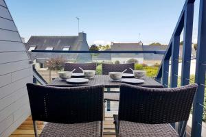a table and chairs sitting on a balcony at Sweet Inn * plage à 200m * in Ploemeur