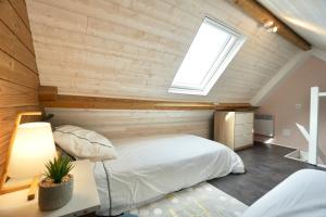 a bedroom with a large bed and a skylight at Sweet Inn * plage à 200m * in Ploemeur