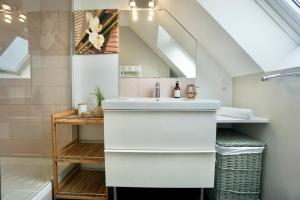 a white bathroom with a sink and a shower at Sweet Inn * plage à 200m * in Ploemeur +22 photos